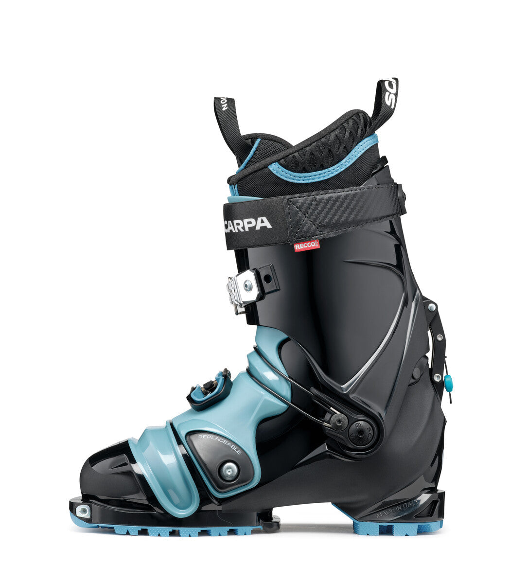 Alpine touring ski boot with light blue lower shell, black upper cuff, and single buckle closure, lateral view