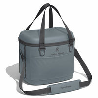 Soft-sided insulated cooler bag with top handles, shoulder strap, and front pocket, angled view
