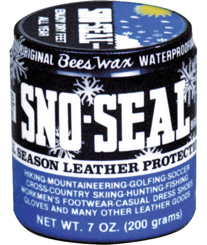 Round tin container of beeswax waterproofing product with blue and black label showing snowflake designs