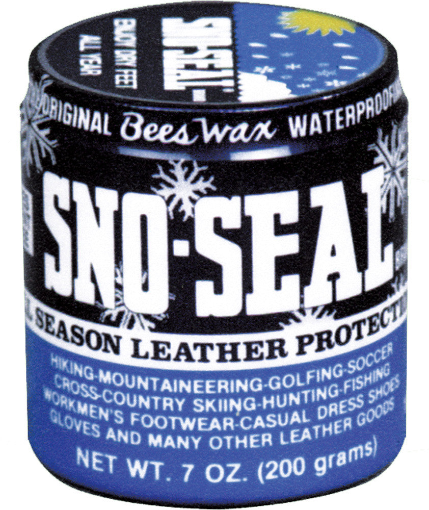 Round tin container of beeswax waterproofing product with blue and black label showing snowflake designs