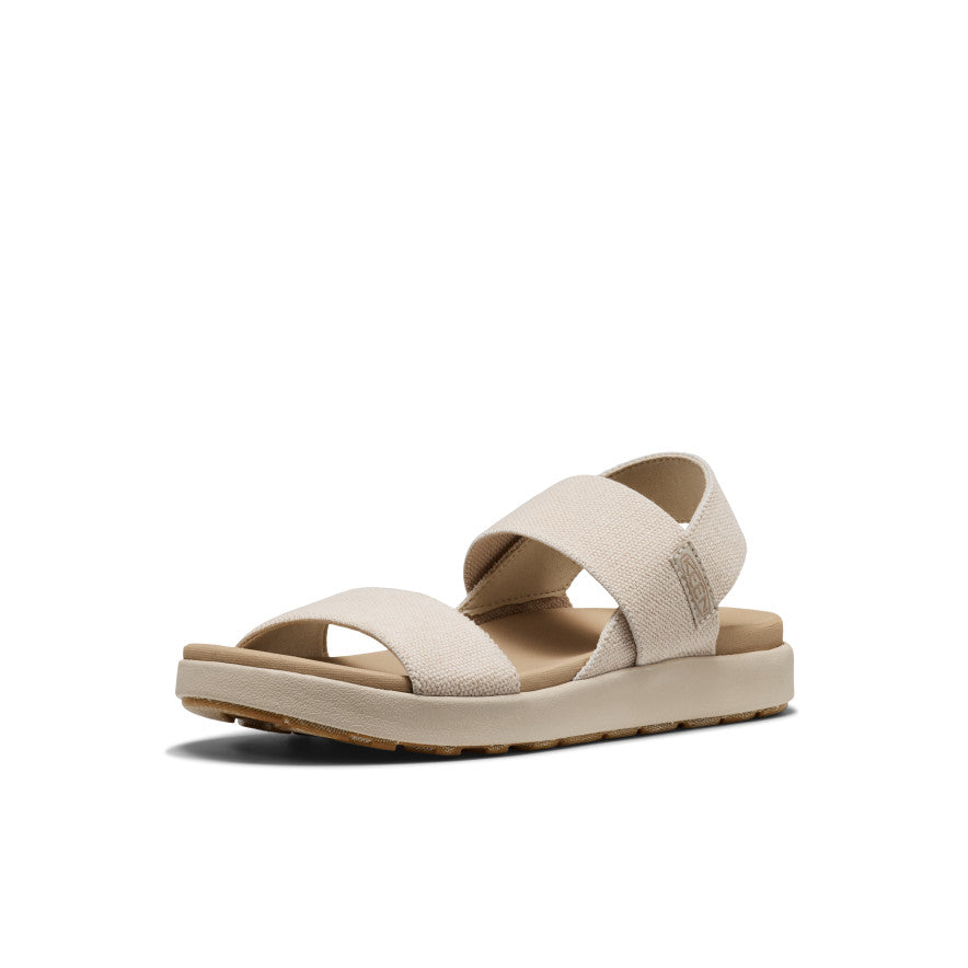 Beige canvas strap sandals with cushioned sole and ankle strap, side view
