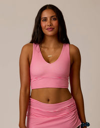 Women's striped pink and white crop top with V-neck and racerback design, front view