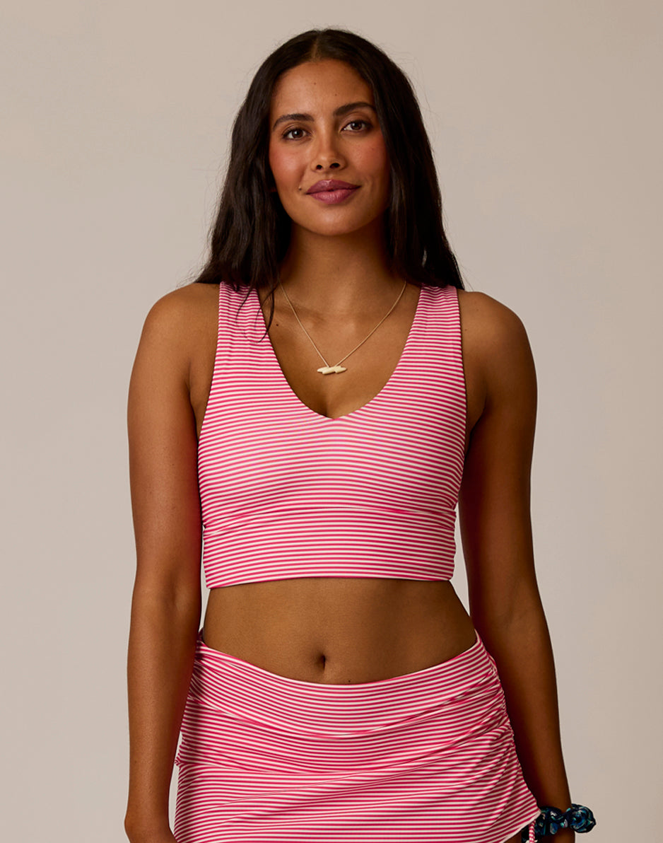 Women's striped pink and white crop top with V-neck and racerback design, front view