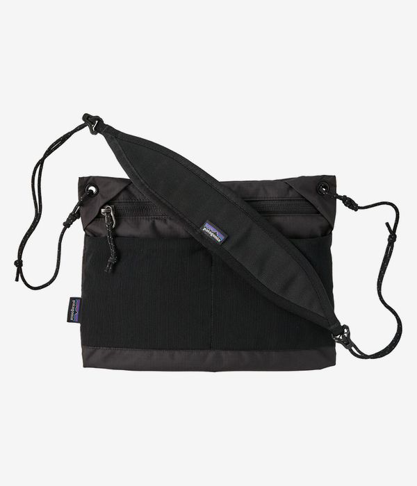 Black crossbody bag with adjustable shoulder strap and front zippered pocket