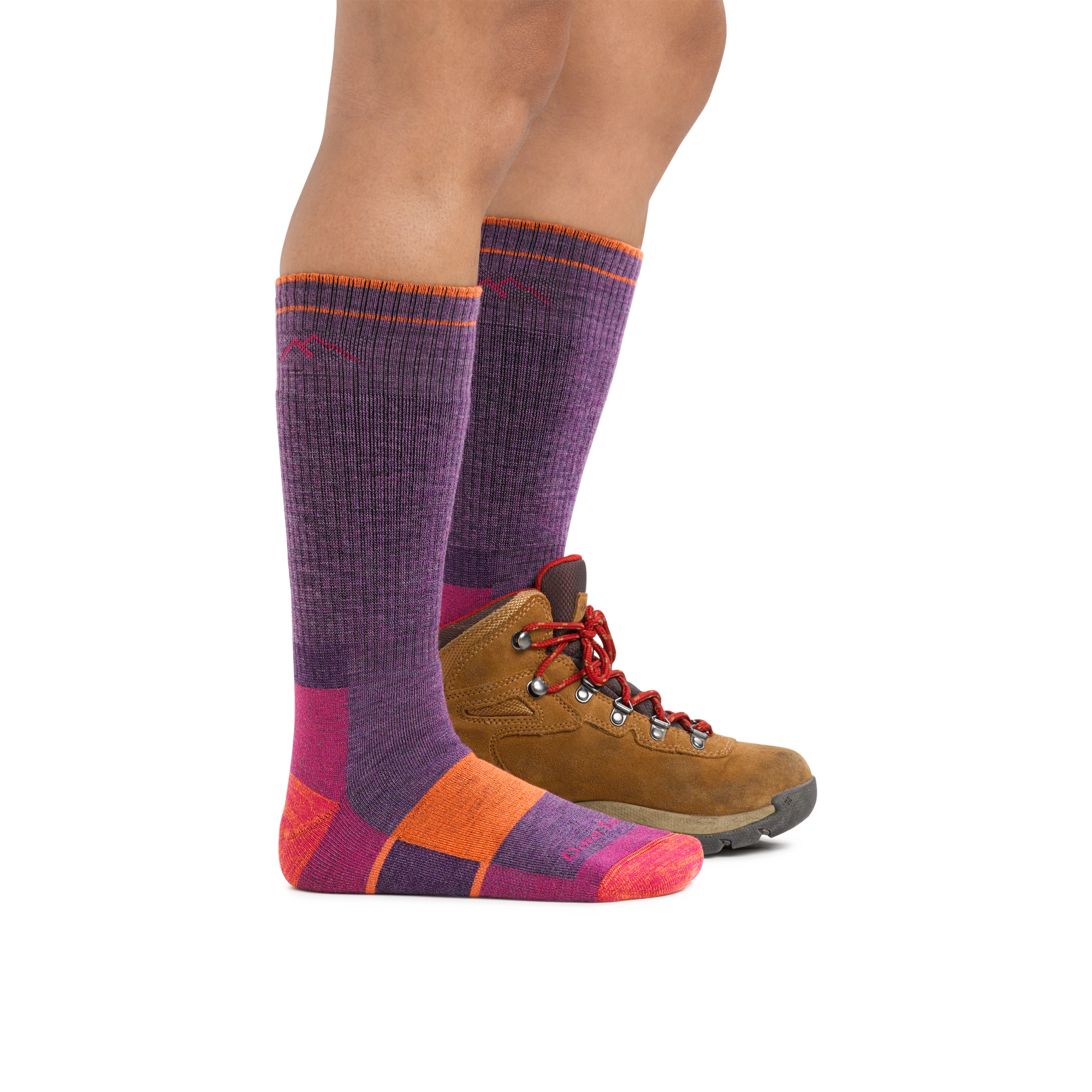 Knee-high wool hiking socks in purple with colorblock sole, shown with brown hiking boot