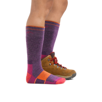 Knee-high wool hiking socks in purple with colorblock sole, shown with brown hiking boot