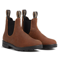 Pair of suede Chelsea boots with elastic side panels, pull tabs, and rubber soles, angled view