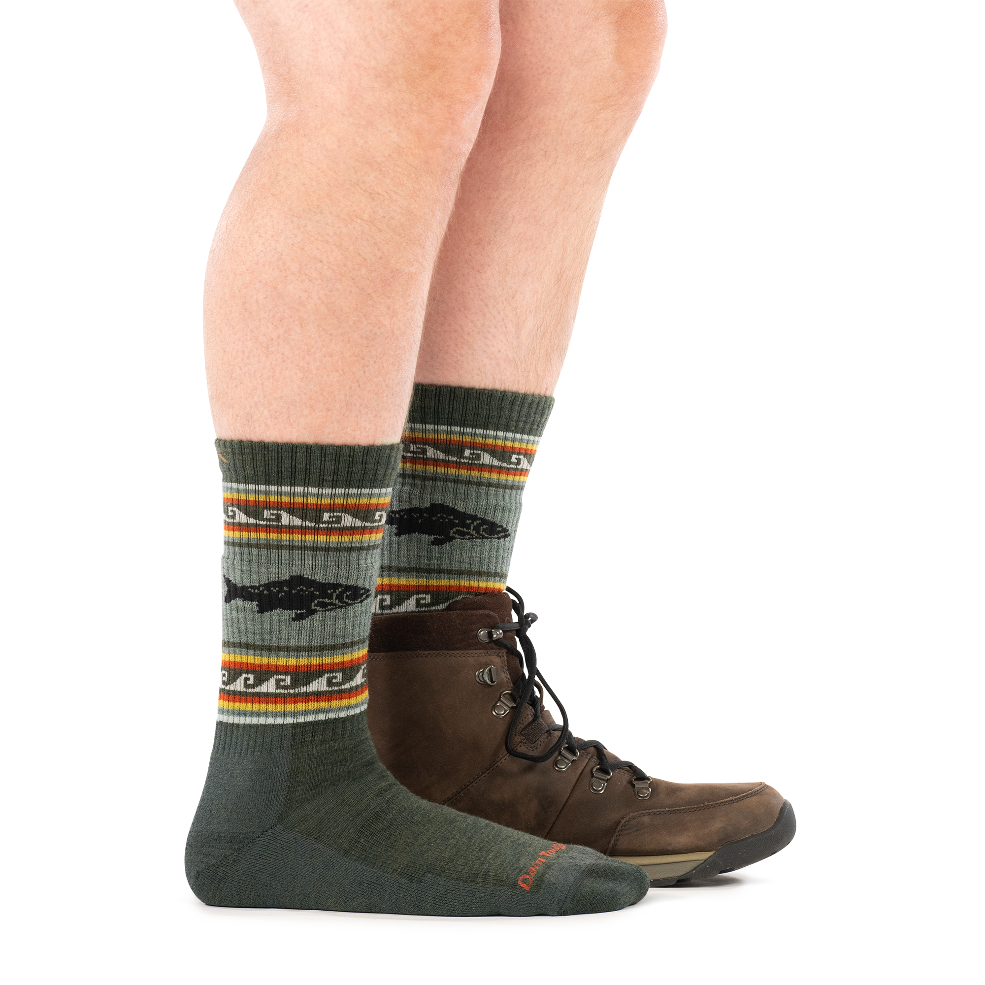 Olive green crew socks with trout fish pattern and striped accents, worn with brown hiking boots