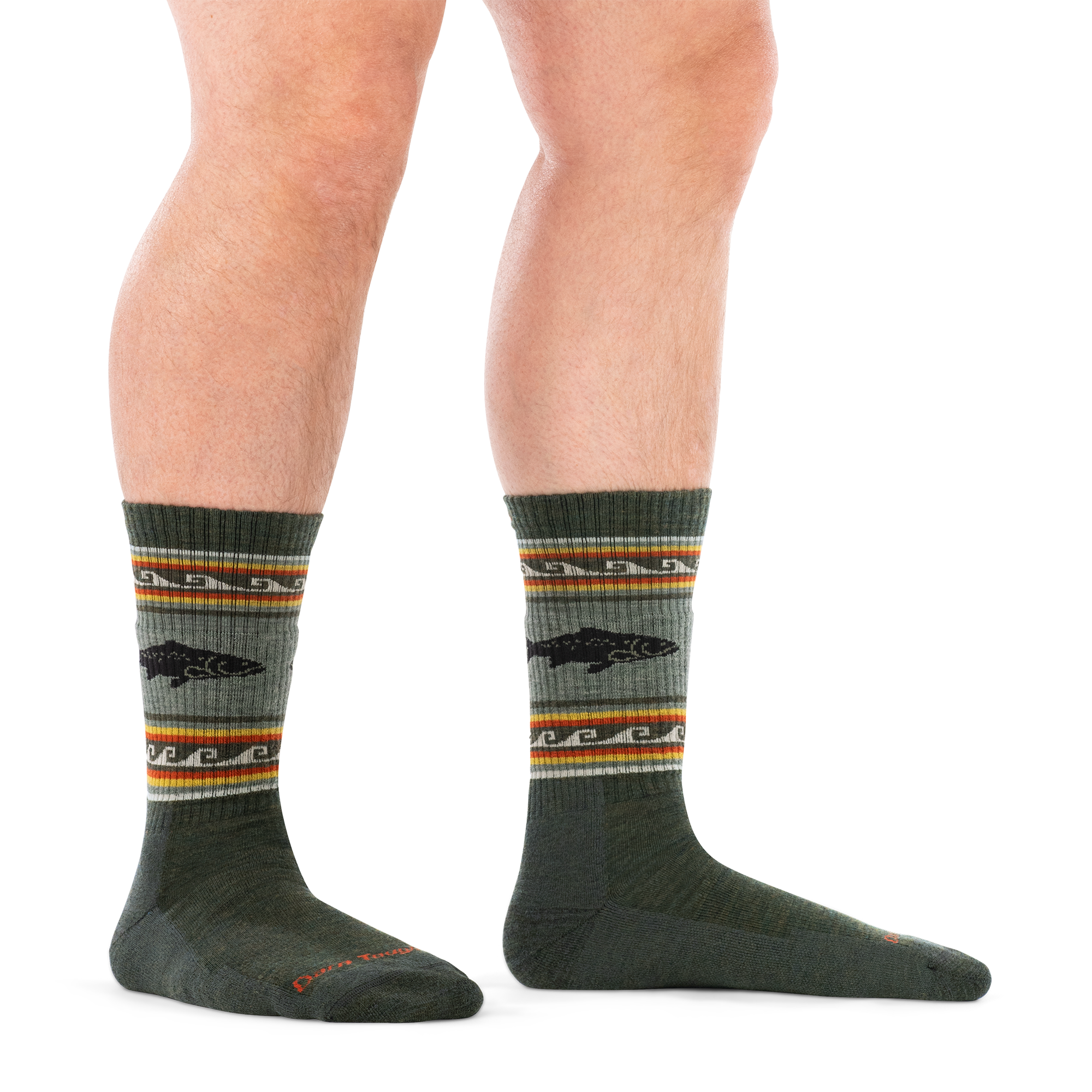 Olive green crew socks with trout fish graphic and multicolor striped band, worn on model