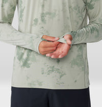 Light green tie-dye hooded sweatshirt with hands clasped at waist, front view