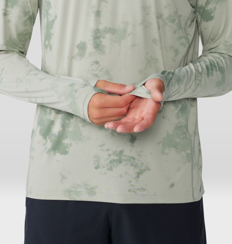 Light green tie-dye hooded sweatshirt with hands clasped at waist, front view