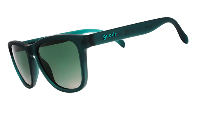 Dark teal sunglasses with gradient green lenses shown from side angle on white background