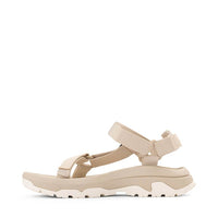 Light beige sport sandal with adjustable straps and chunky sole, side profile view