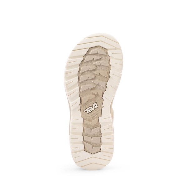 Bottom view of beige outdoor sandal showing textured rubber outsole with grip pattern