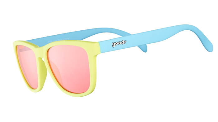 Yellow and blue sunglasses with pink mirrored lenses shown from side angle