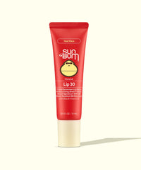 Red tinted sunscreen lip balm tube with SPF 30 protection in coconut scent