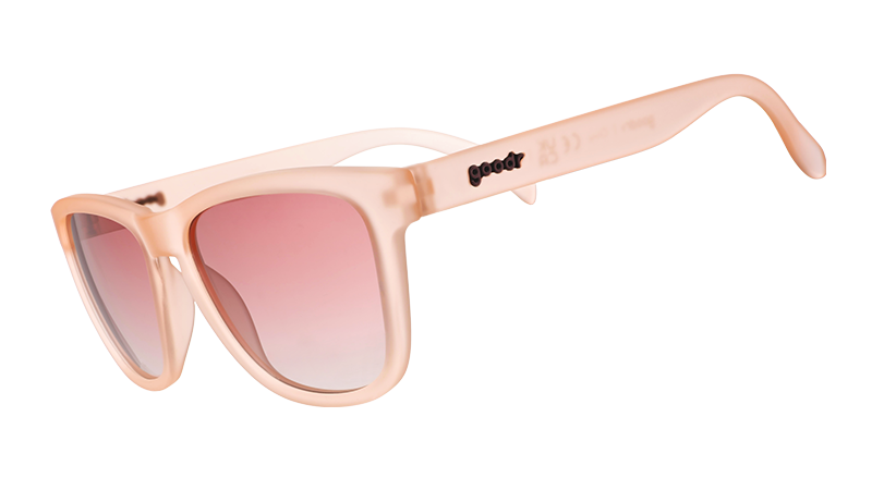 Translucent peachy-pink sunglasses with oversized square frames and gradient rose-tinted lenses
