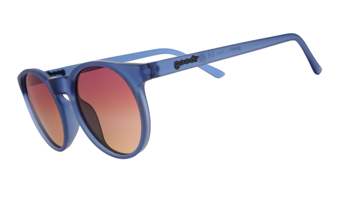Round sunglasses with blue tortoiseshell frames and gradient orange-brown lenses, side angle view