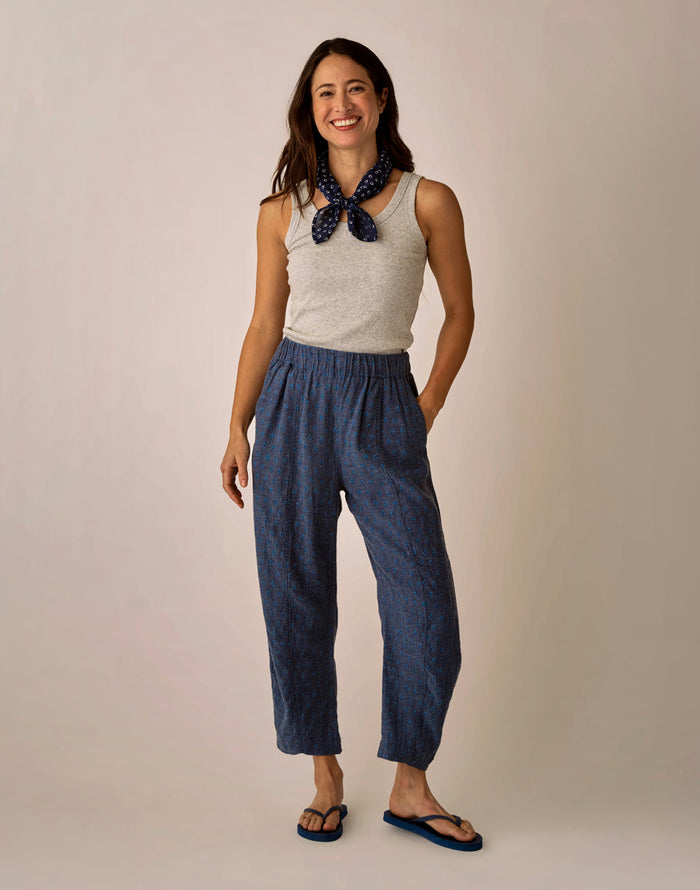 Navy blue patterned linen pants with elastic waist and relaxed fit, worn by model