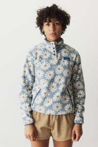 Light blue fleece pullover with white daisy print, snap-button collar and zip pocket