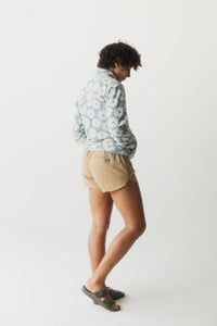 Light blue floral print fleece pullover worn by woman, back and side view