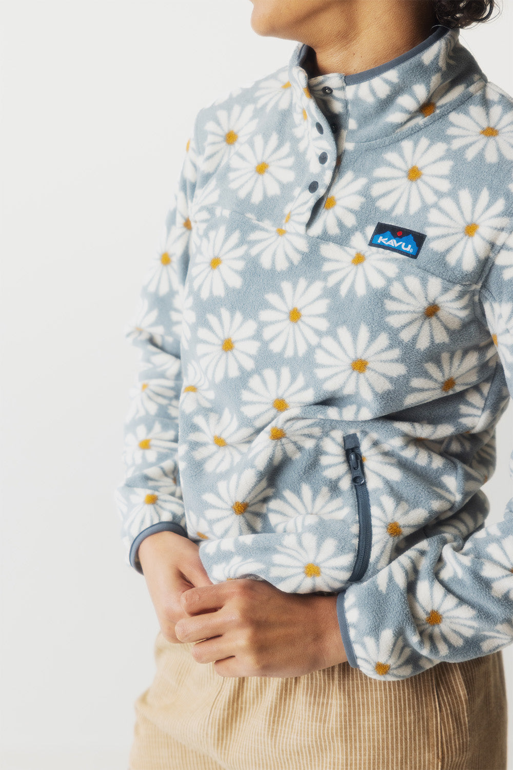 Light blue fleece pullover with white daisy pattern, snap collar and chest pocket