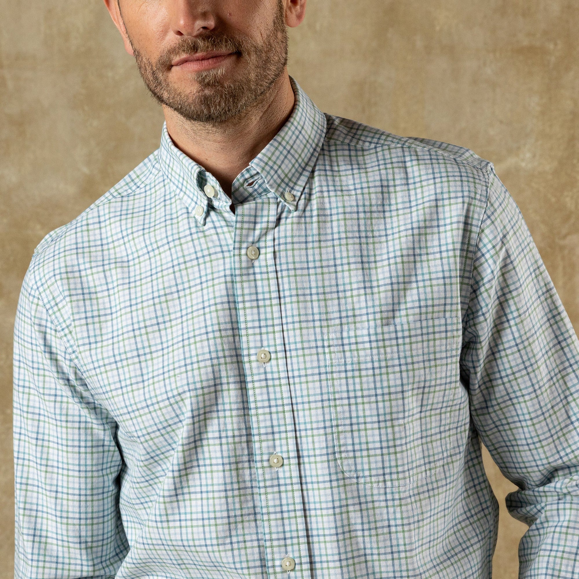 Light plaid button-down shirt with collar and long sleeves, front view on model
