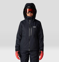 Women's insulated ski jacket in black, front view, worn with helmet and goggles