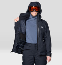 Women's insulated ski jacket in black, open to show interior lining, worn with goggles