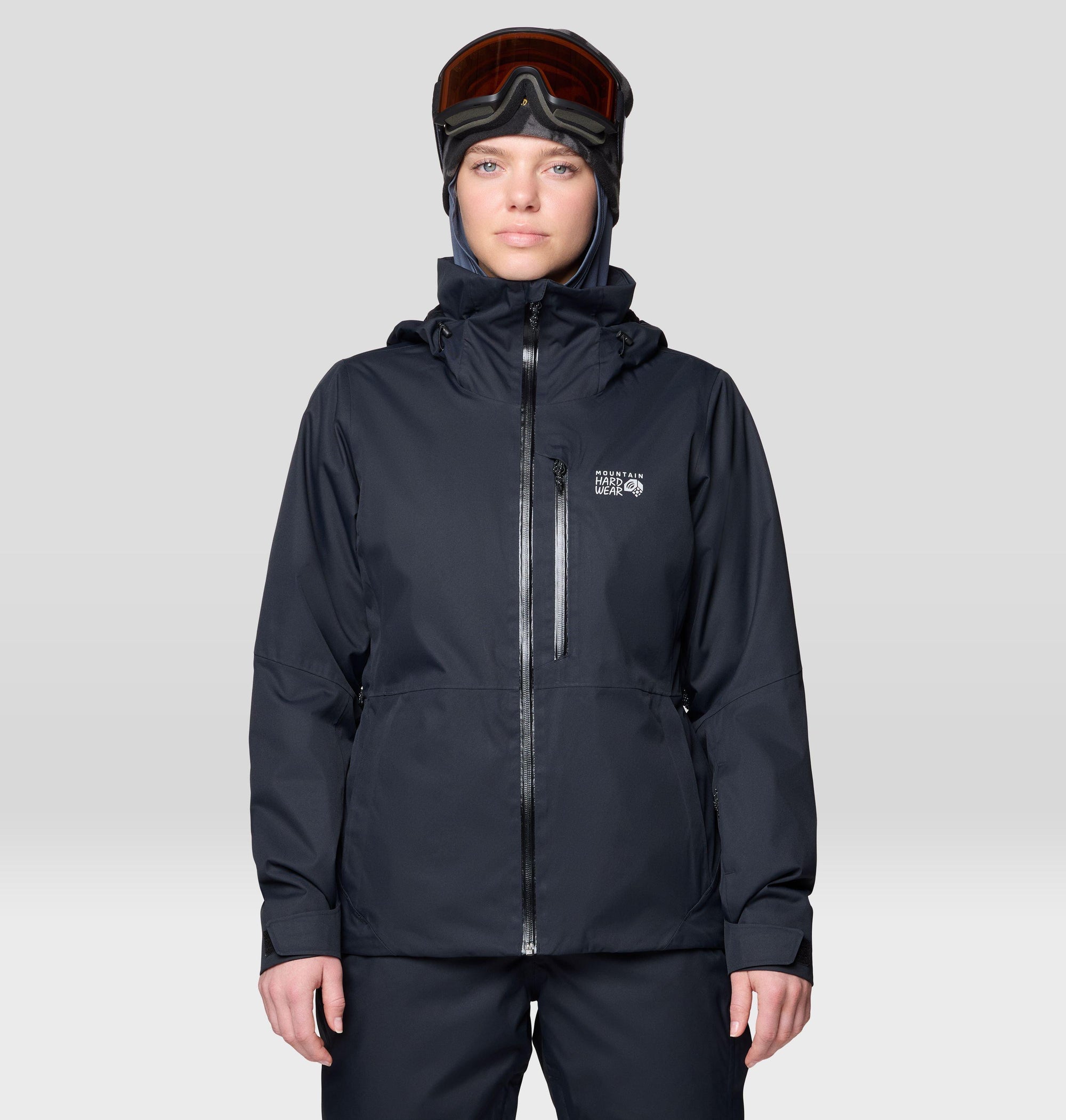 Women's insulated ski jacket in black, front view, with hood and ski goggles