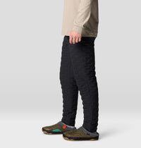 Black quilted insulated pants shown from side angle on male model with slip-on shoes