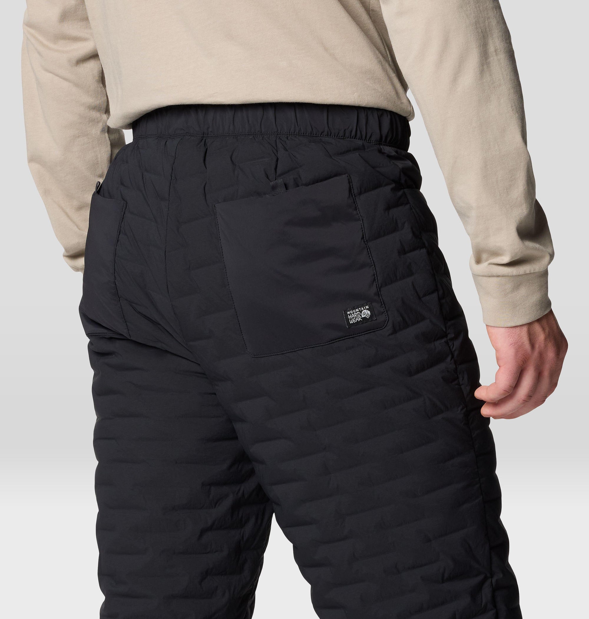 Black quilted insulated pants back view showing elastic waistband and back pocket