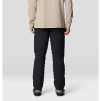 Black quilted insulated men's pants, back view, shown on model with casual shoes