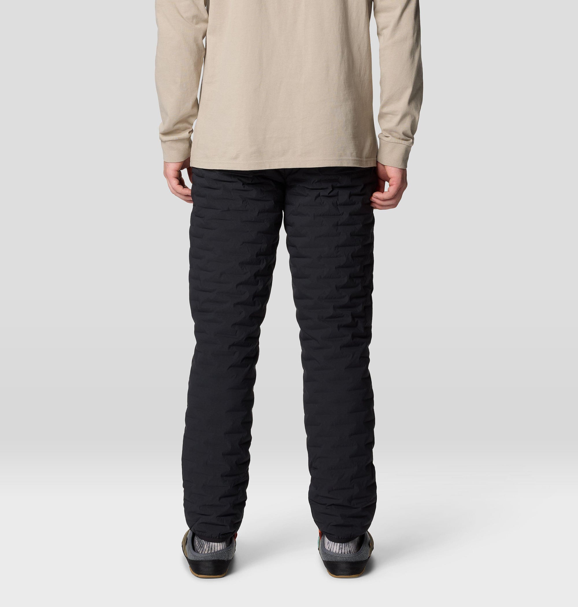 Black quilted insulated pants, back view on male model, horizontal baffle stitching detail