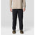 Black quilted insulated pants with textured baffling, front view on male model