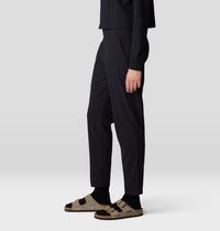 Black ankle-length pants with relaxed fit and tapered legs, side view on model