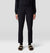 Black ankle-length pants with tapered fit and elastic cuffs, front view on model