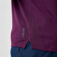 Deep purple athletic short sleeve shirt with side seam detail and brand logo