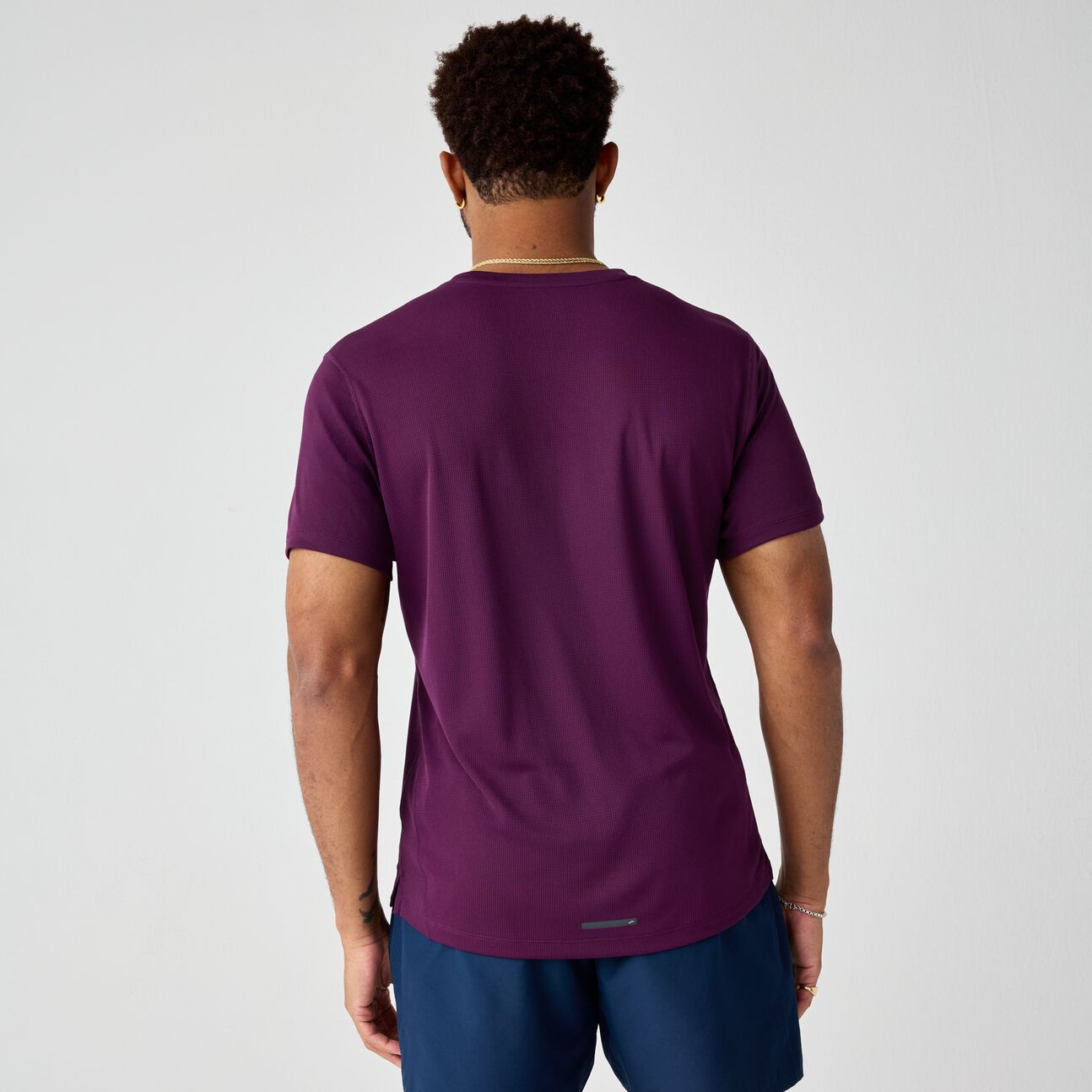 Deep purple athletic short sleeve shirt shown from back view on male model