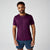 Man wearing deep purple short sleeve athletic t-shirt with blue shorts