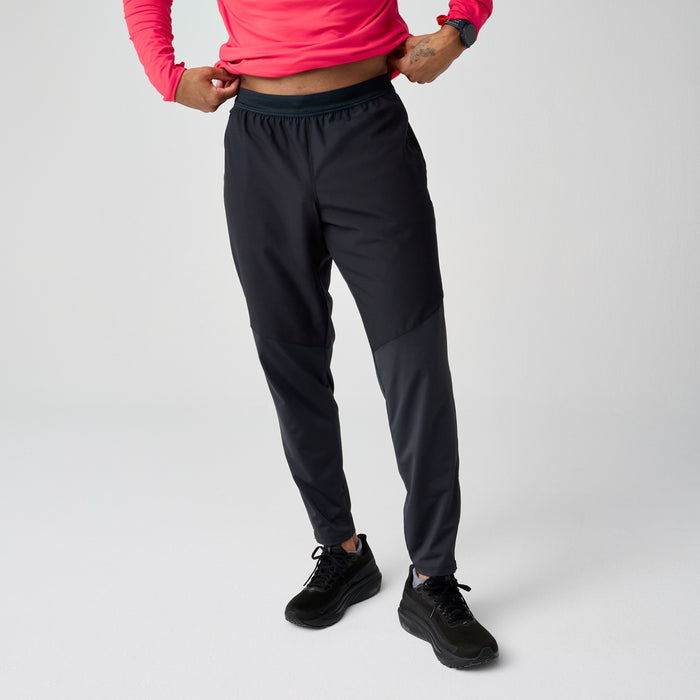 Black athletic running pants with tapered fit and elastic waistband, modeled front view