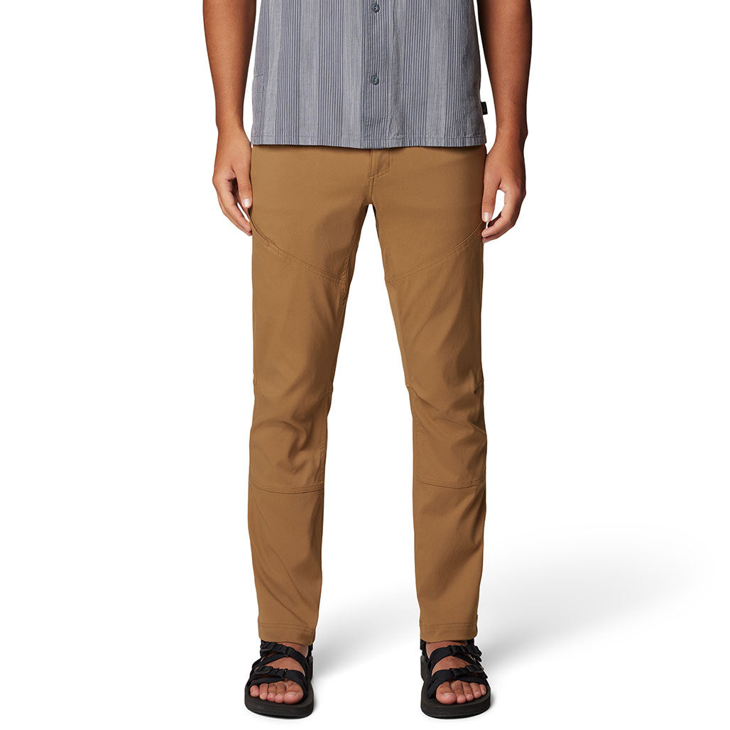 Tan brown outdoor pants with articulated knees worn with striped shirt and sandals