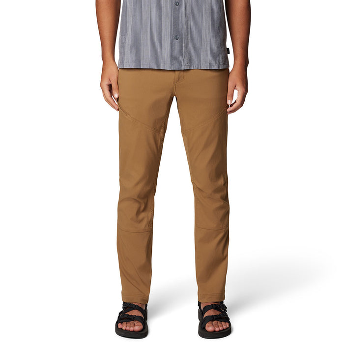 Tan brown outdoor pants with articulated knees worn with striped shirt and sandals