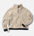 Cream grid-fleece half-zip pullover with black cuffs, hem trim, and quarter-zip collar, flat lay view