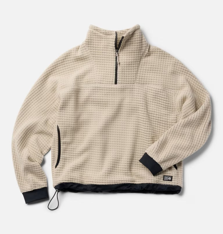Cream grid-fleece half-zip pullover with black cuffs, hem trim, and quarter-zip collar, flat lay view