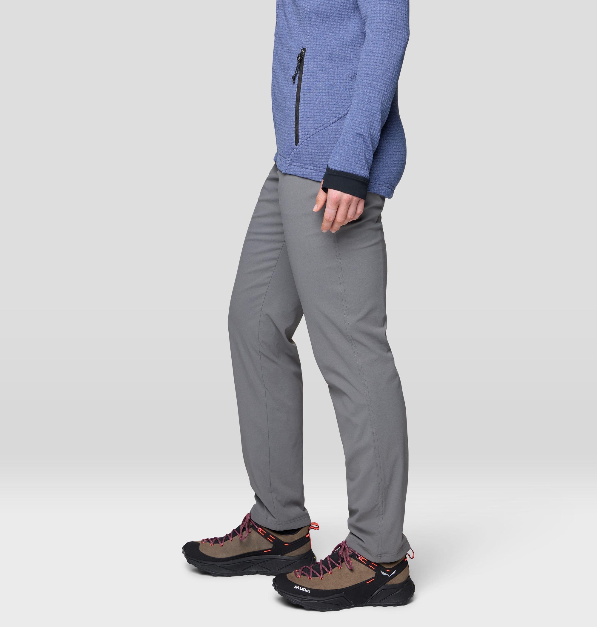 Gray slim-fit lined pants side view, worn with hiking shoes and blue fleece top