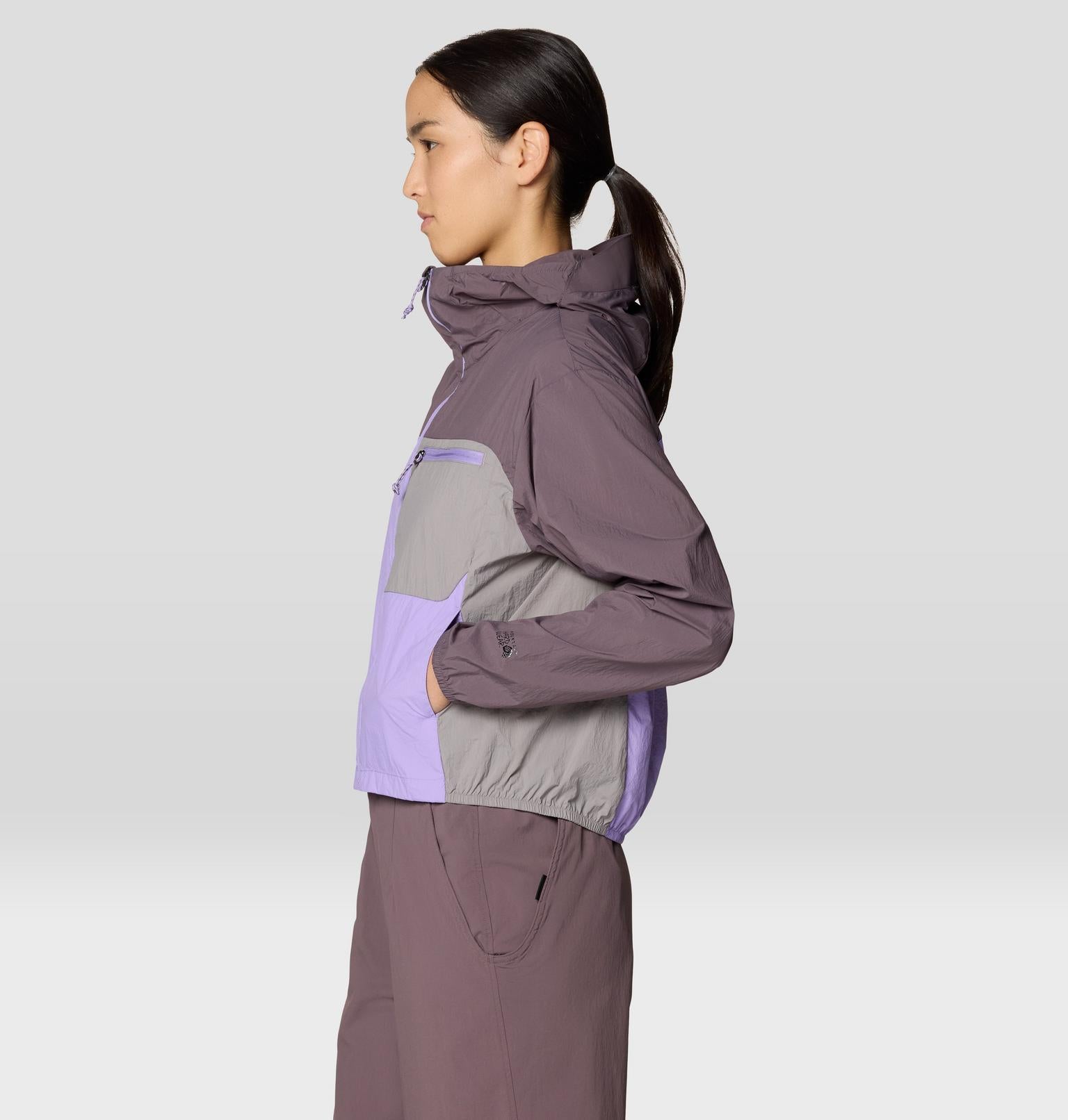 Purple and gray colorblock windbreaker jacket with hood, side profile view on model