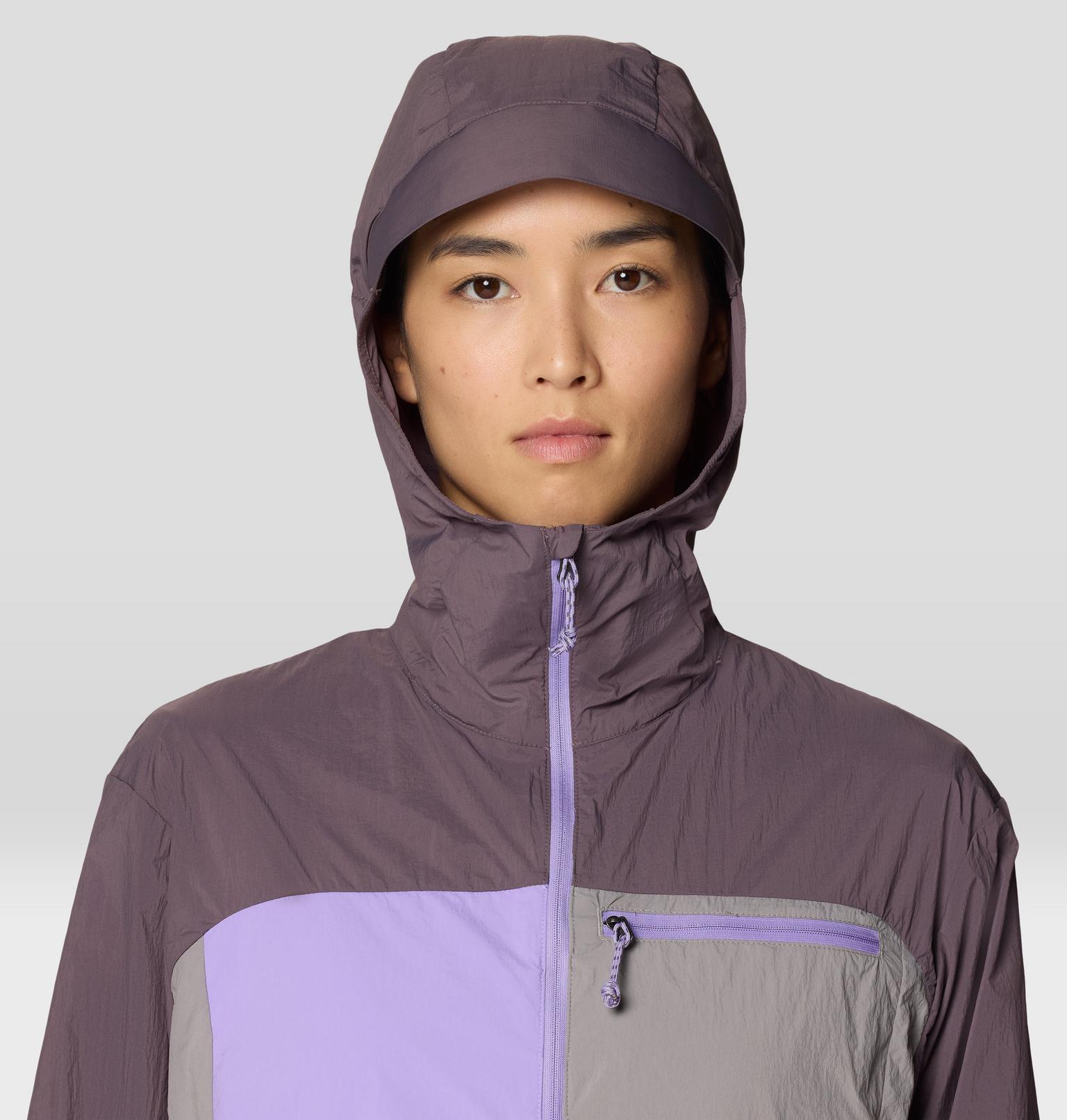 Hooded windbreaker jacket in purple and gray colorblock design with front zip closure