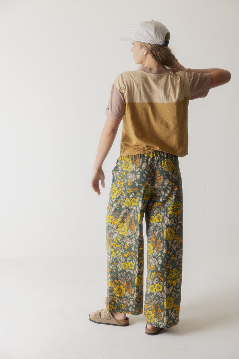 Two-tone color block shirt with tan upper section and mustard yellow lower section, back view