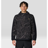 Men's pullover fleece hoodie with tree-branch camo print front panel and solid black sleeves, front view
